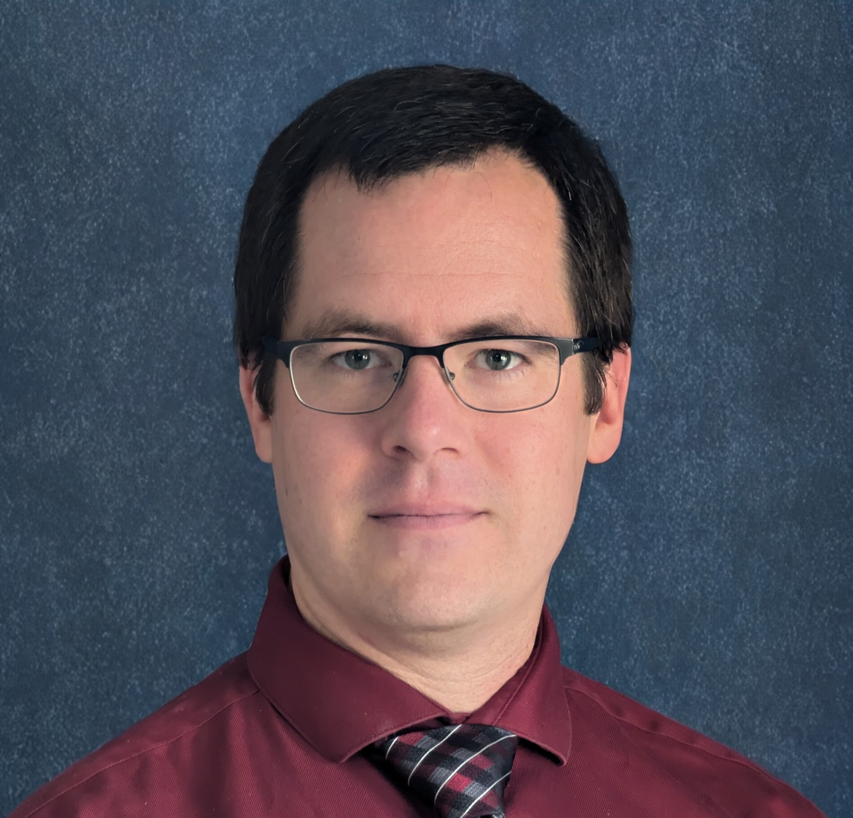 Headshot of Aaron Buster